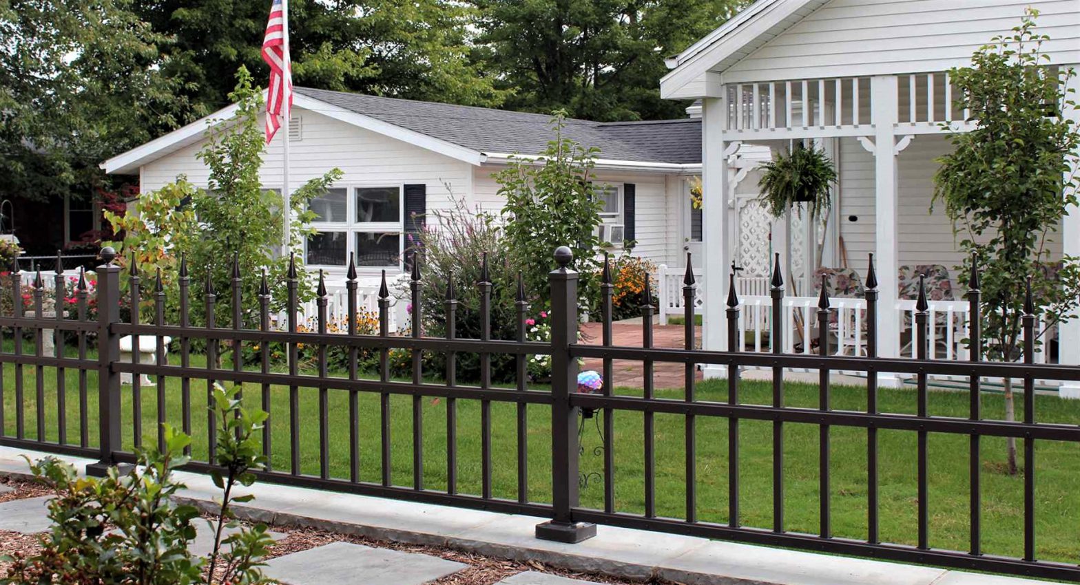 Photo of an aluminum fence in front of a residential home